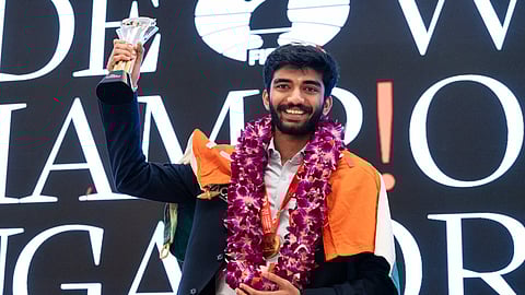 Gukesh with FIDE World Chess Championship trophy.
