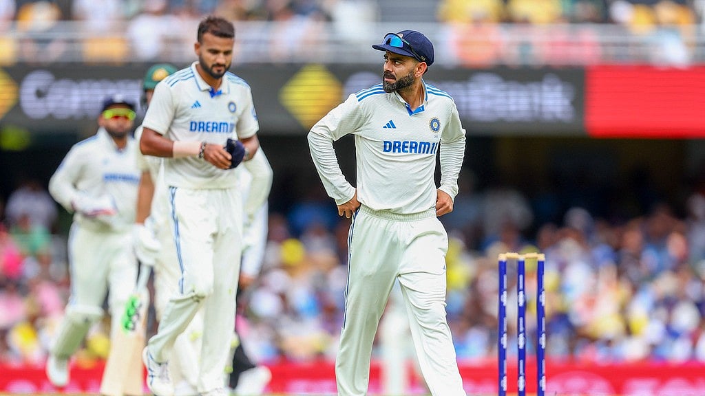 Virat Kohli walks back to his fielding position during play on day one of the third Test between India and Australia at the Gabba in Brisbane. - AP