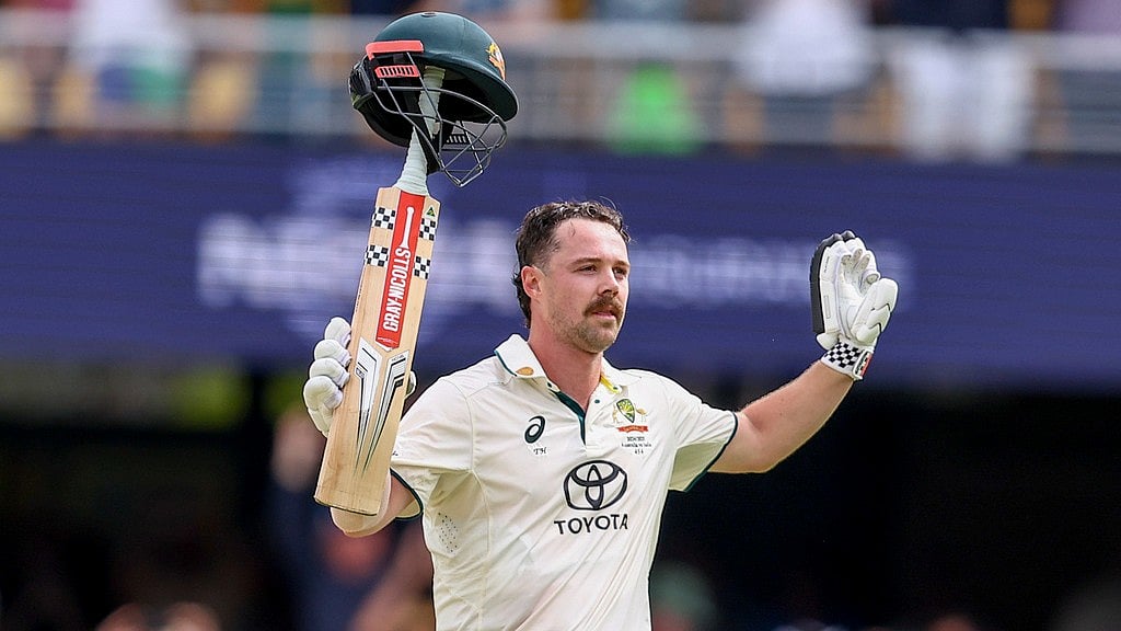 Australia's Travis Head celebrates after scoring a century during play on day two of the third cricket test between India and Australia at the Gabba in Brisbane, Australia, Sunday, Dec.15, 2024. 
 - (AP Photo/Pat Hoelscher)