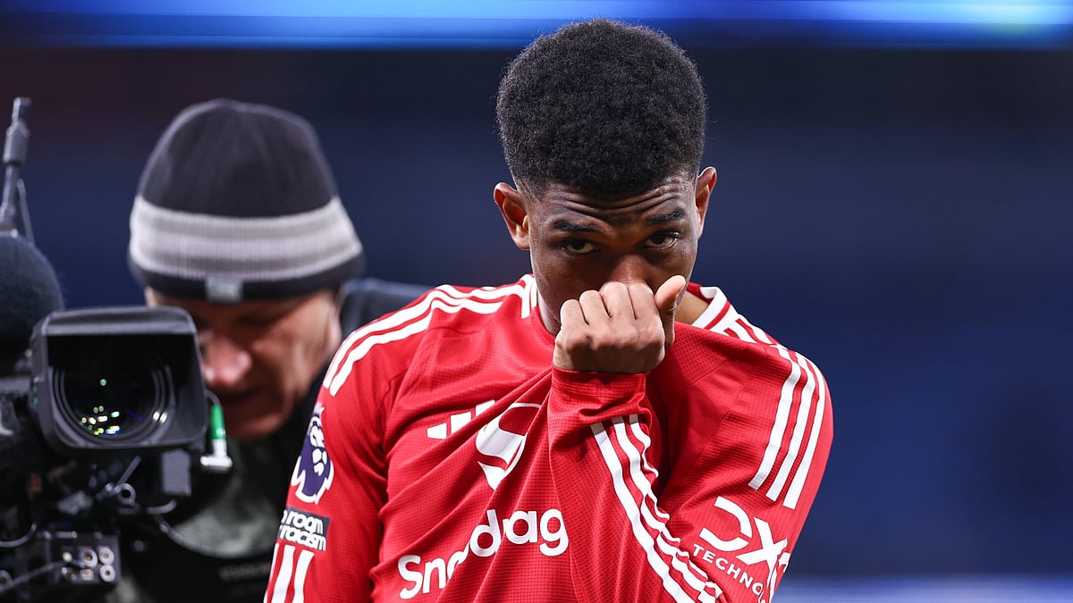 Amad Diallo kisses the Manchester United badge after his derby winner - null