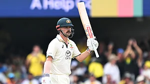 Travis Head celebrates after bringing up his ninth Test century.