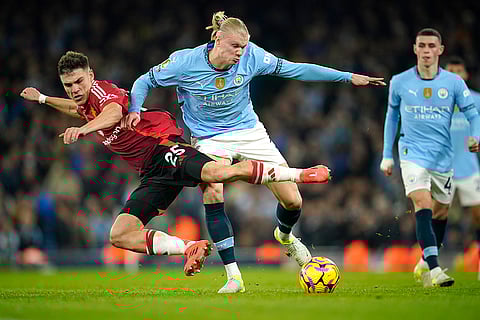 EPL 2024-25: Man City's Erling Haaland, center, challenges for the ball with Man United's Manuel Ugarte