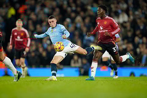 EPL 2024-25: Manchester City's Phil Foden kicks the ball ahead of Manchester United's Kobbie Mainoo