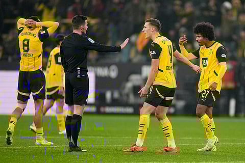 Bundesliga 2024-25: Dortmund's Karim Adeyemi, right, reacts after receiving a yellow card