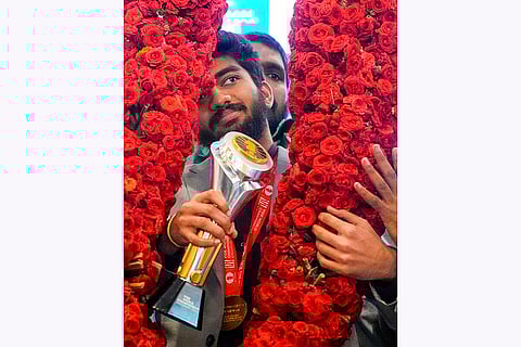 D Gukesh being garlanded during a press conference