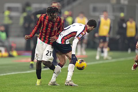 Serie A 2024-25: AC Milan's Samuel Chukwueze, left, challenges for the ball with Genoa's Aaron Martin