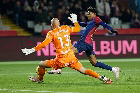 La liga 2024-25: Barcelona's Lamine Yamal and Leganes' goalkeeper Marko Dmitrovic challenge for the ball