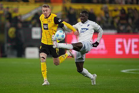 Bundesliga 2024-25: Hoffenheim's Stanley Nsoki, right, is challenged by Dortmund's Maximilian Beier