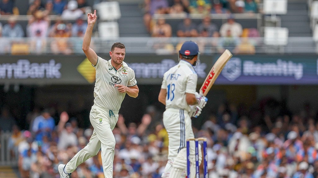 AP/Pat Hoelscher : Australia's Josh Hazlewood, left, celebrates the wicket of India's Virat Kohli, right, during play on day three of the third cricket test between India and Australia at the Gabba in Brisbane, Australia, Monday, Dec. 16, 2024.