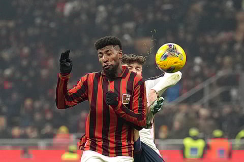 Serie A 2024-25: AC Milan's Emerson Royal, left, challenges for the ball with Genoa's Vitinha