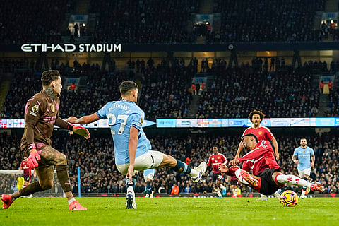 EPL 2024-25: Manchester City's Matheus Nunes, center, fouls Manchester United's Amad Diallo to concede a penalty