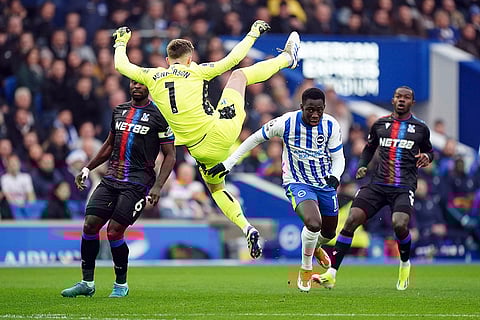 EPL 2024-25: Crystal Palace goalkeeper Dean Henderson, center and Brighton and Hove Albion's Yankuba Minteh vie for the ball
