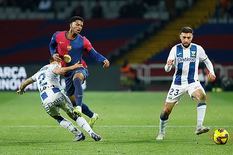 La liga 2024-25: Leganes' Munir El Haddadi and Adria Altimira challenge for the ball with Barcelona's Alejandro Balde