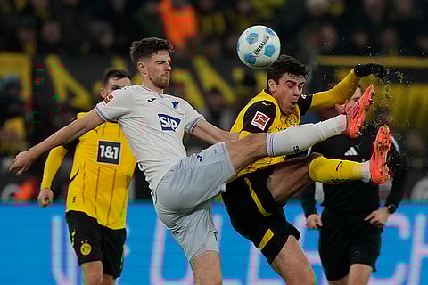 Bundesliga 2024-25: Hoffenheim's Anton Stach, left, fights for the ball with Dortmund's Giovanni Reyna