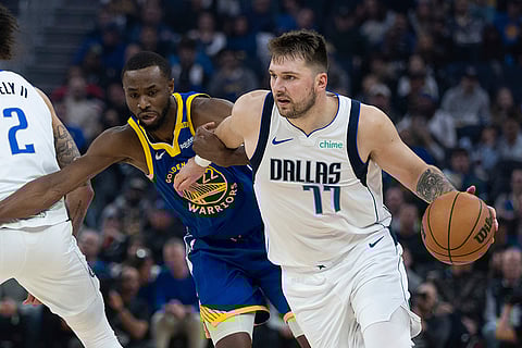NBA 2024-25: Warriors forward Andrew Wiggins defends against Mavericks forward Luka Dončić