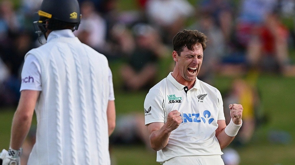 Andrew Cornaga/Photosport via AP                  : Matt Henry celebrates the wicket of Zak Crawley, right, during play on day three of the third Test between England and New Zealand in Hamilton.