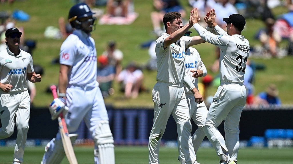Andrew Cornaga/Photosport via AP               : Matt Henry celebrates the wicket of Ollie Pope on day four of the third Test between England and New Zealand in Hamilton.
