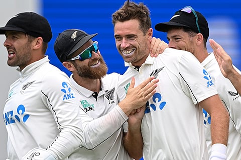 Tim Southee of New Zealand is congratulated by his teammates after dismissing Jacob Bethell of England.