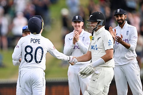 Tim Southee of New Zealand is welcomed to the crease by England's Ollie Pope and teammates.
