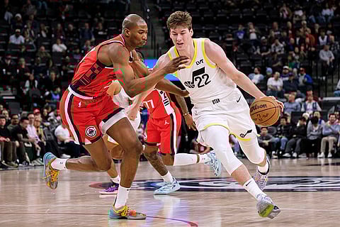 NBA 2024-25: Jazz forward Kyle Filipowski (22) drives the ball past  Clippers forward Kai Jones