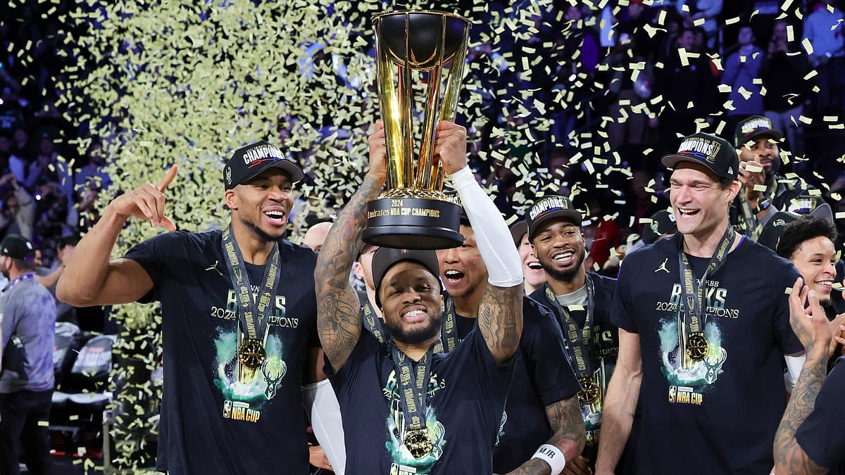 Giannis Antetokounmpo, Damian Lillard and Brook Lopez of the Milwaukee Bucks celebrate with the championship trophy after the Bucks defeated the Oklahoma City Thunder 97-81 to win the championship game of the Emirates NBA Cup at T-Mobile Arena on December 17, 2024, in Las Vegas, Nevada.