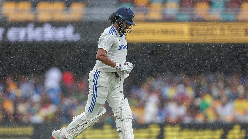 AP : India's KL Rahul runs back to the pavilion as it starts to rain during play on day three of the third cricket test between India and Australia at the Gabba in Brisbane, Australia, Monday, Dec. 16, 2024.

