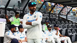 AP Photo/Pat Hoelscher : India's captain Rohit Sharma waits for play to start on day three of the third cricket test between India and Australia at the Gabba in Brisbane.