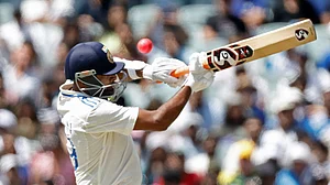 AP Photo/James Elsby : India's Ravichandran Ashwin plays a shot to be caught behind by Australia's wicketkeeper Alex Carey during day three of the second cricket test match between Australia and India at the Adelaide Oval in Adelaide.