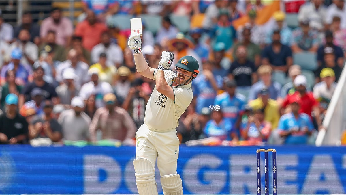 AP Photo/Pat Hoelscher : Australia's Travis Head plays a shot during play on day five of the third cricket test between India and Australia at the Gabba in Brisbane.