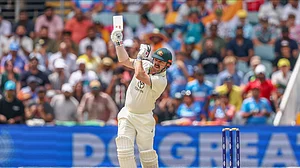 AP Photo/Pat Hoelscher : Australia's Travis Head plays a shot during play on day five of the third cricket test between India and Australia at the Gabba in Brisbane.