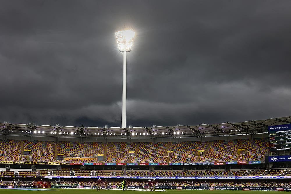Photo: AP/Pat Hoelscher : India Vs Australia, 3rd Test Day 5: Rain clouds hover above the Gaba as rain interrupts the play