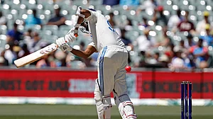AP Photo/James Elsby : India's Ravichandran Ashwin attempts to play a shot during day three of the second cricket test match between Australia and India at the Adelaide Oval in Adelaide.