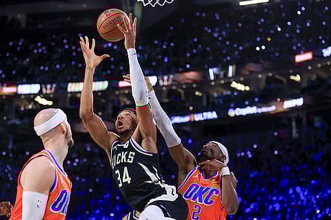 NBA Cup Final: Bucks forward Giannis Antetokounmpo (34) and Thunder guard Shai Gilgeous-Alexander (2) contest for a rebound
