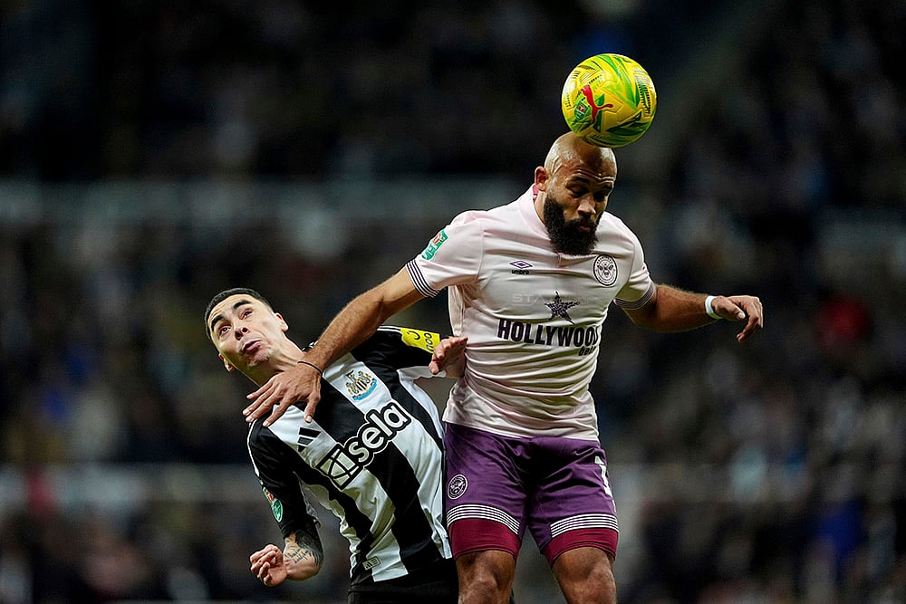 | Photo: Owen Humphreys/PA via AP : EFL Cup Quarter-Finals: Brentford's Bryan Mbeumo heads the ball in front of Newcastle United's Miguel Almiron