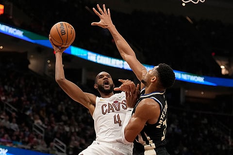 NBA 2024-25: Cavaliers forward Evan Mobley (4) shoots as Bucks forward Giannis Antetokounmpo