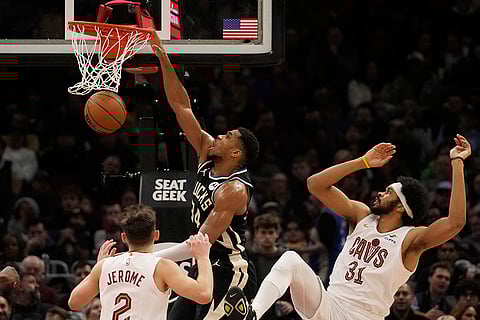 NBA 2024-25: Bucks forward Giannis Antetokounmpo (34) dunks between Cavaliers guard Ty Jerome