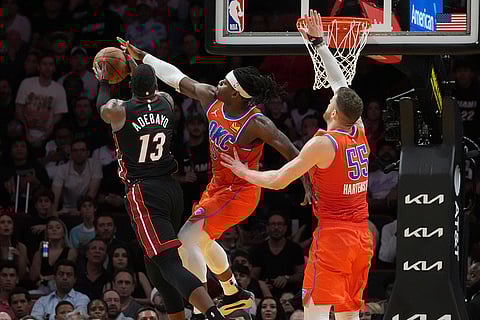 NBA 2024-25: Thunder guard Luguentz Dort (5) blocks a drive to the basket by Heat center Bam Adebayo