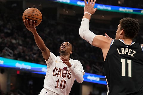 NBA 2024-25: Cavaliers guard Darius Garland (10) goes to the basket next to Bucks center Brook Lopez