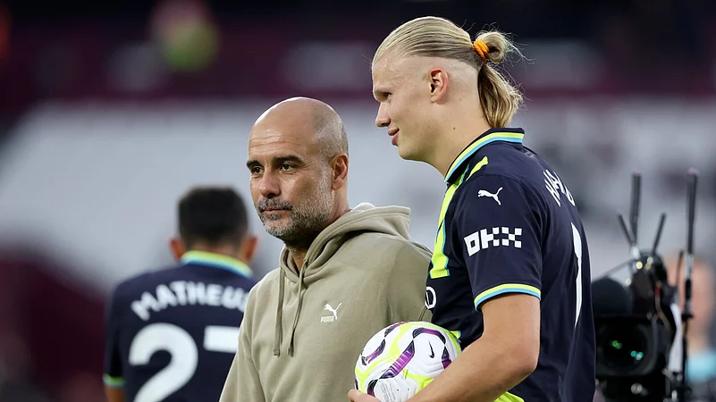 Manchester City manager Pep Guardiola with striker Erling Haaland