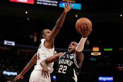 NBA 2024-25: Bucks forward Khris Middleton (22) goes to the basket past Cavaliers forward Evan Mobley