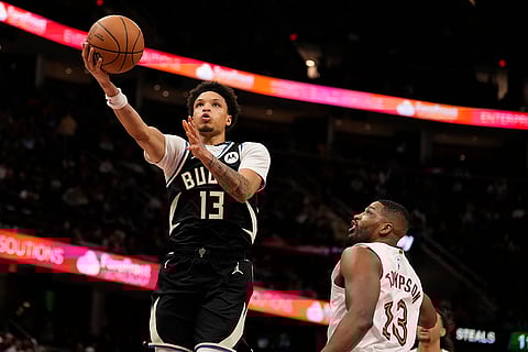 NBA 2024-25: Bucks guard Ryan Rollins (13) goes to the basket past Cavaliers center Tristan Thompson