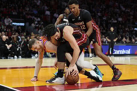 NBA 2024-25: Thunder center Isaiah Hartenstein and Heat guard Jaime Jaquez Jr. (11) go after a loose ball