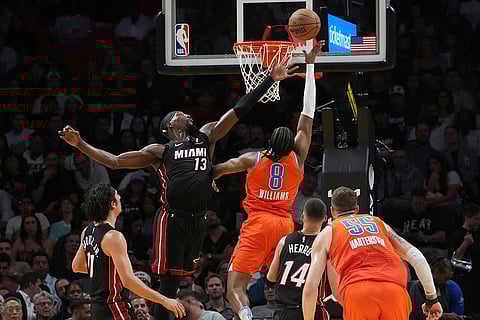 NBA 2024-25: Thunder forward Jalen Williams (8) drives to the basket as Heat center Bam Adebayo (13) defends