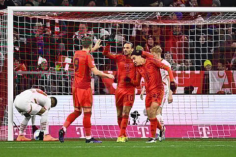 Bundesliga 2024-25: Munich's Jamal Musiala, right, celebrates scoring