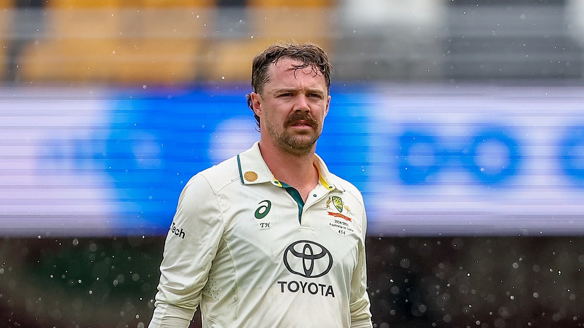 AP Photo/Pat Hoelscher : Australia's Travis Head leaves the field as it rains during play on day four of the third cricket test between India and Australia at the Gabba in Brisbane.