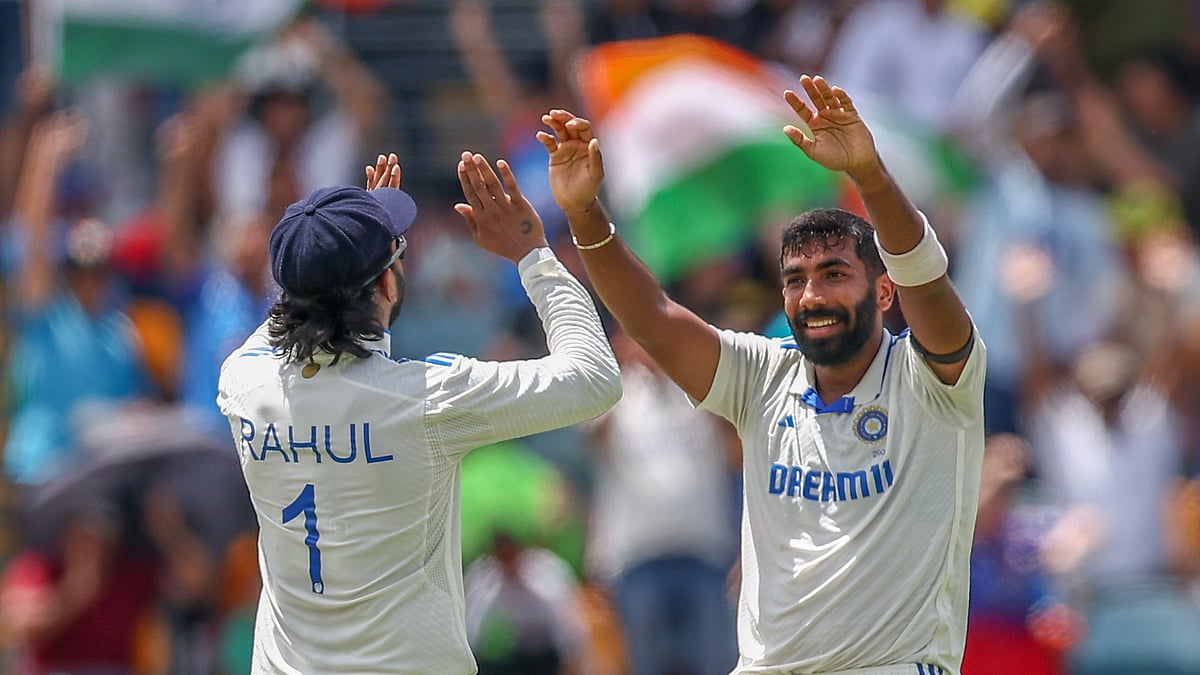 India's Jasprit Bumrah, right, and KL Rahul celebrate the wicket of Australia's Marnus Labuschagne during play on day five of the third cricket test between India and Australia at the Gabba in Brisbane. - AP Photo/Pat Hoelscher