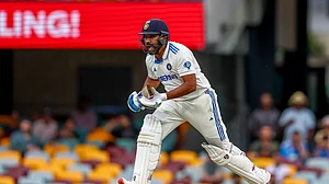AP Photo/Pat Hoelscher : India's captain Rohit Sharma bats during play on day three of the third cricket test between India and Australia at the Gabba in Brisbane.