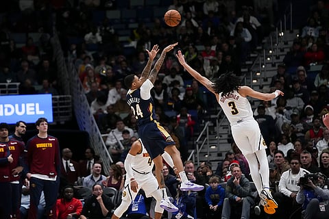 NBA 2024-25: Pelicans guard Jordan Hawkins (24) shoots against Nuggets guard Julian Strawther