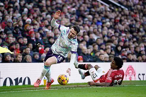 EPL 2024-25: Manchester United's Tyrell Malacia, right, fouls Bournemouth's Adam Smith