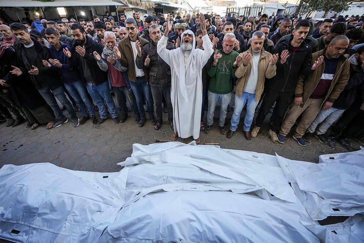 AP Photo/Abdel Kareem Hana : Palestinians pray over the bodies of the victims of an Israeli strike on a home late Saturday before the funeral outside the Al-Aqsa Martyrs Hospital in Deir al-Balah Sunday, Dec. 22, 2024. At least eight people were killed according to the hospital which received the bodies.